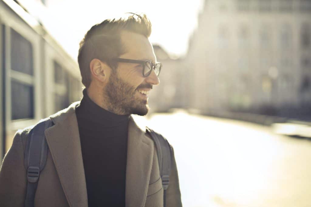 man with confidence stands in the street